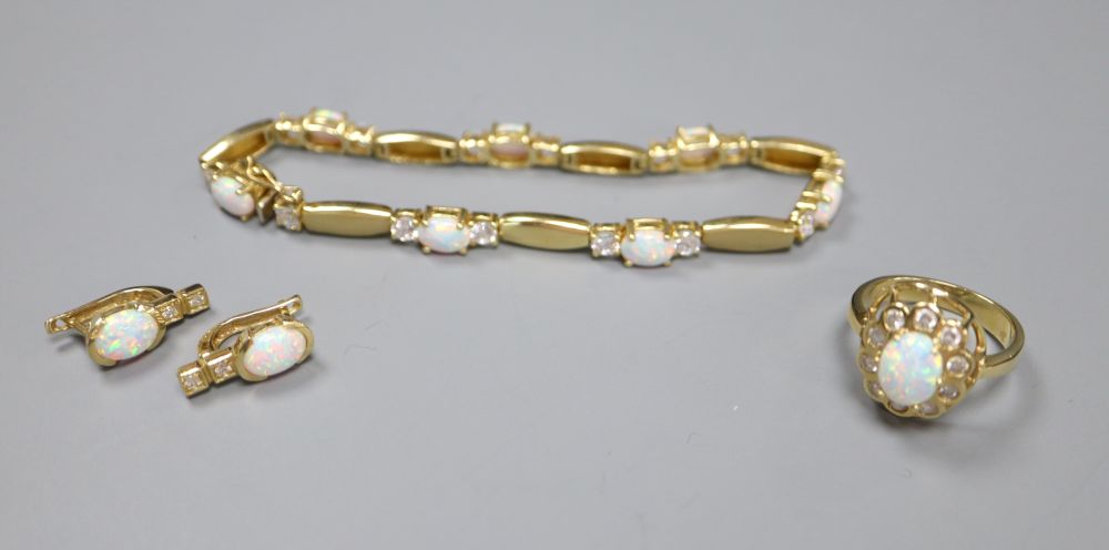 A pair of 585, white opal and paste stud earrings and a similar paste-set bracelet and ring ensuite, gross 21.6g.